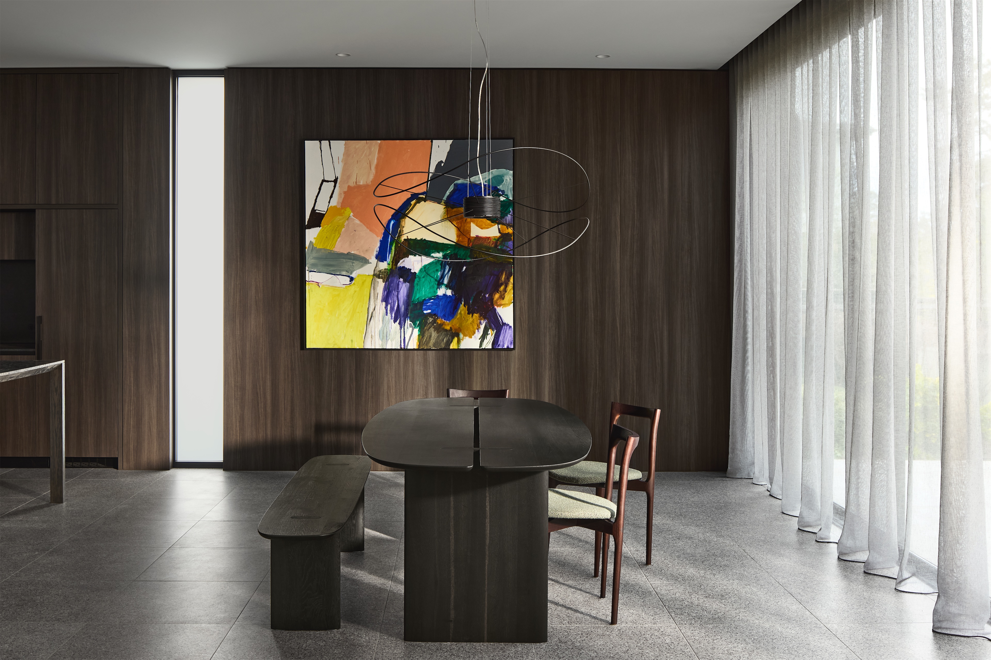 dining room with dark timber table and bench, large abstract painting and timber-panelled wall, opus 24, ashburton