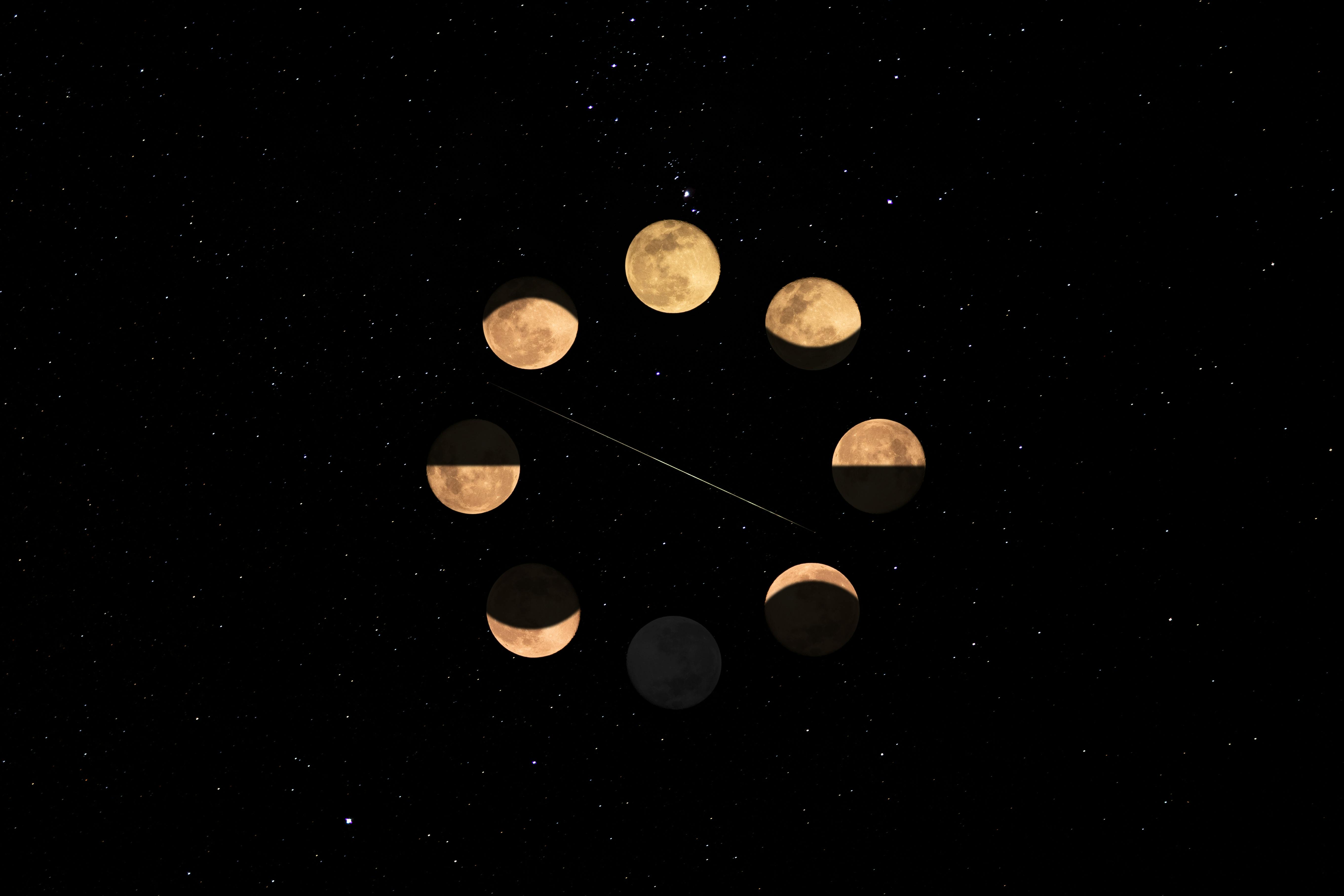 Phases of the moon in a circular formation over a star-filled night sky, symbolizing the cyclical nature of awareness and inner reflection.