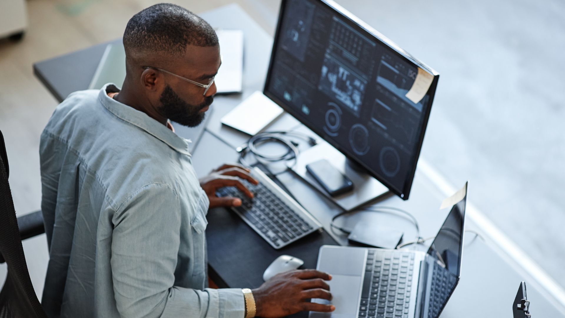 Developer sitting at desk looking at Dynamics 365 performance dashboard