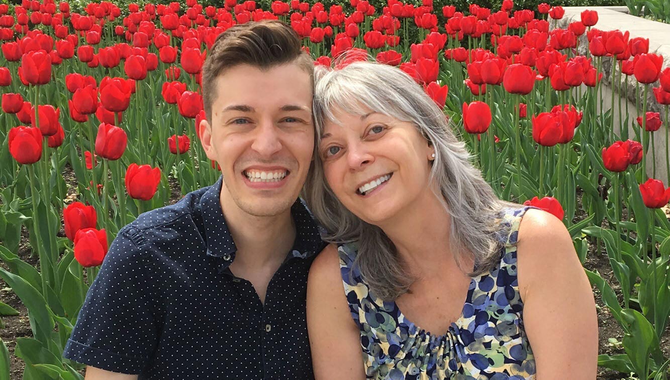 Spencer Patton Desrosiers with his mome in a field of tulips