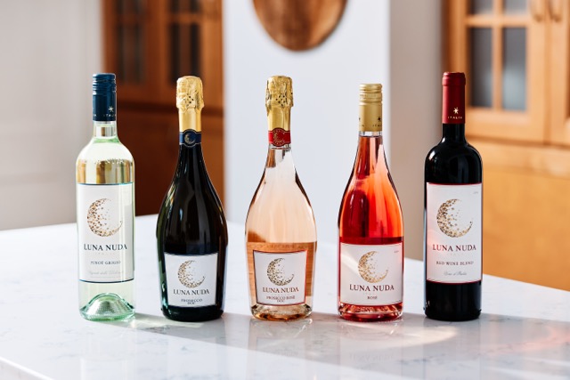 All five Luna Nuda wine bottles lined up together on a marble counter