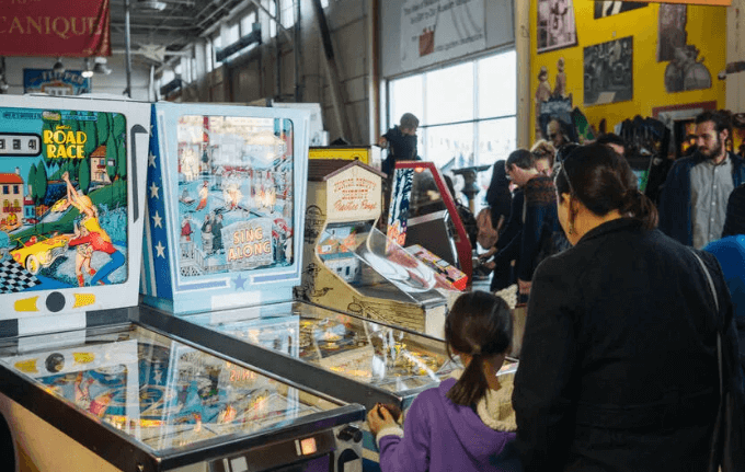 Families exploring interactive exhibits and science displays at a Bay Area children's museum during a community free admission day.