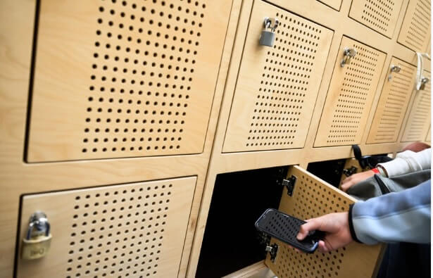 Student placing smartphone into Yondr pouch at a Bay Area high school before the July 2026 California AB 3216 phone-free school deadline
