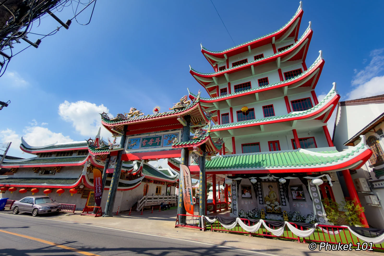 Kathu Shrine in Phuket, Thailand, featuring traditional Chinese architecture with red-and-green roofs and an ornate entrance gate.