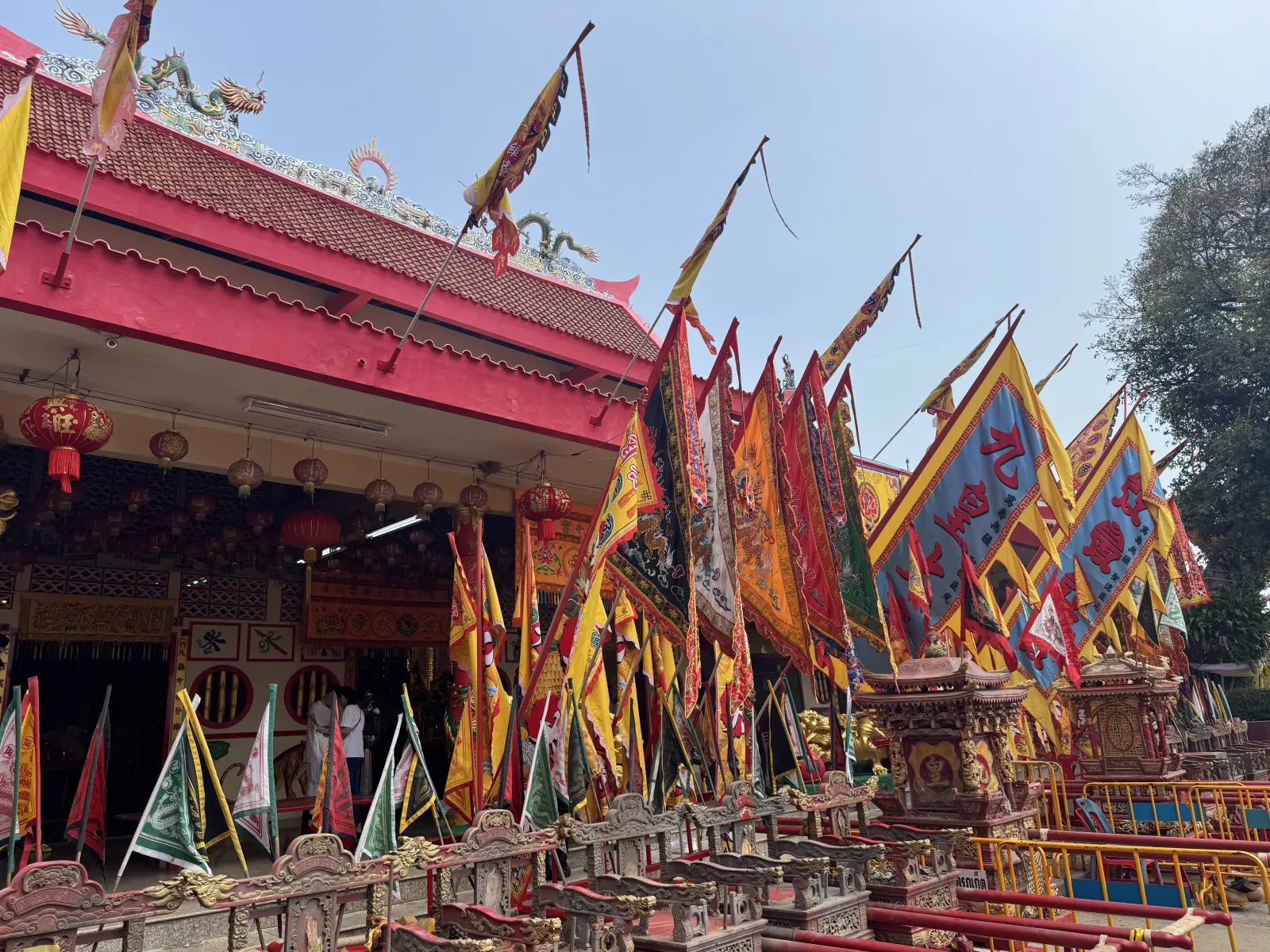 Bang Neow Shrine in Phuket decorated with colorful ceremonial flags and festival equipment for the Phuket Vegetarian Festival
