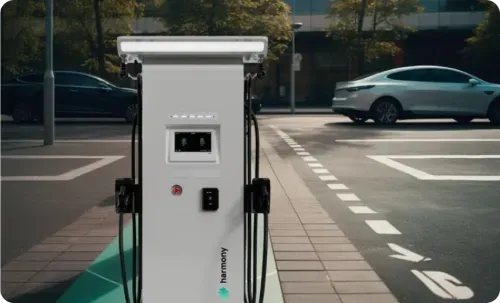 EV charging station on city street with cars nearby.