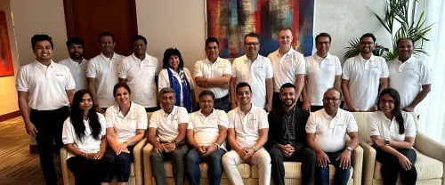 Exicom team members posing indoors on sofas.
