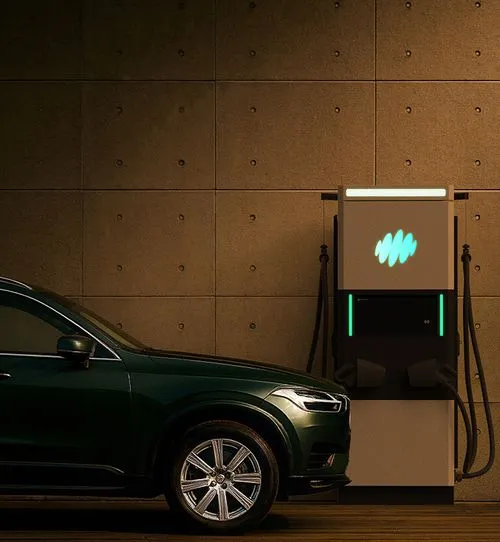 Electric SUV plugged into Harmony charging station at night