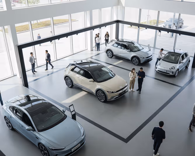 Electric vehicles displayed in modern showroom.