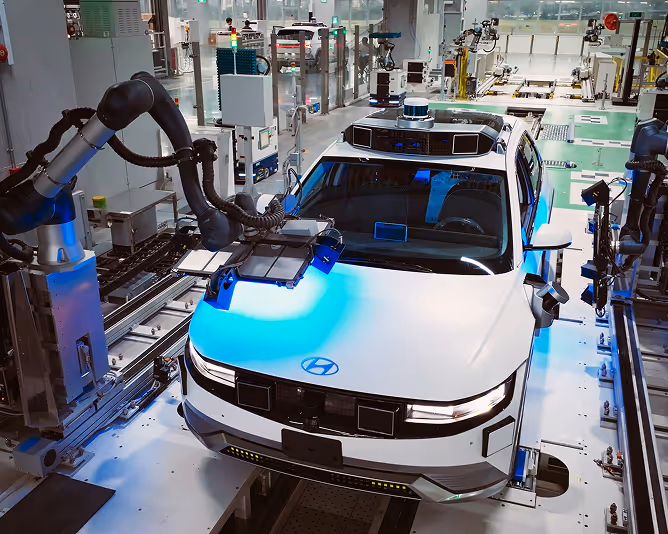Electric vehicle under robotic inspection at automotive manufacturing plant.