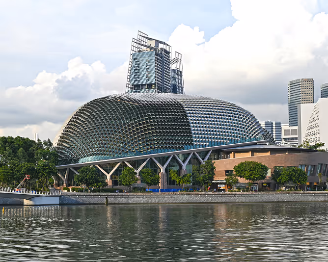 Modern waterfront building with distinctive architectural dome.