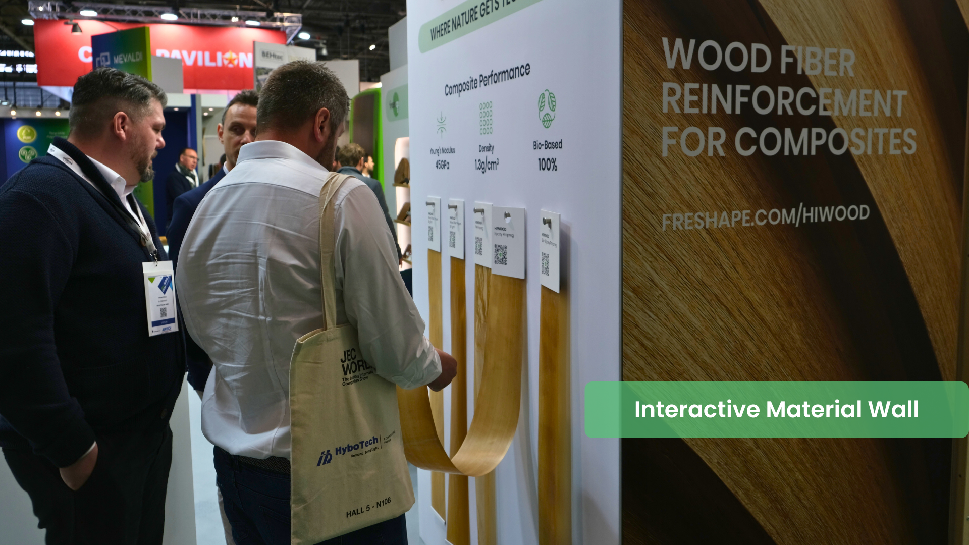 Engineer interacting with HiWood fiber paper material wall displaying Bio-epoxy, PA Prepreg, and more