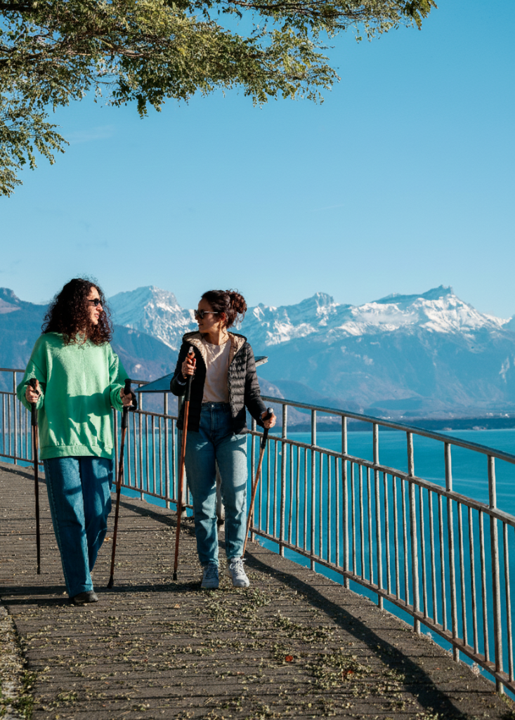 Two women Nordic walking in a Swiss mountain landscape with lightweight HiWalking poles
