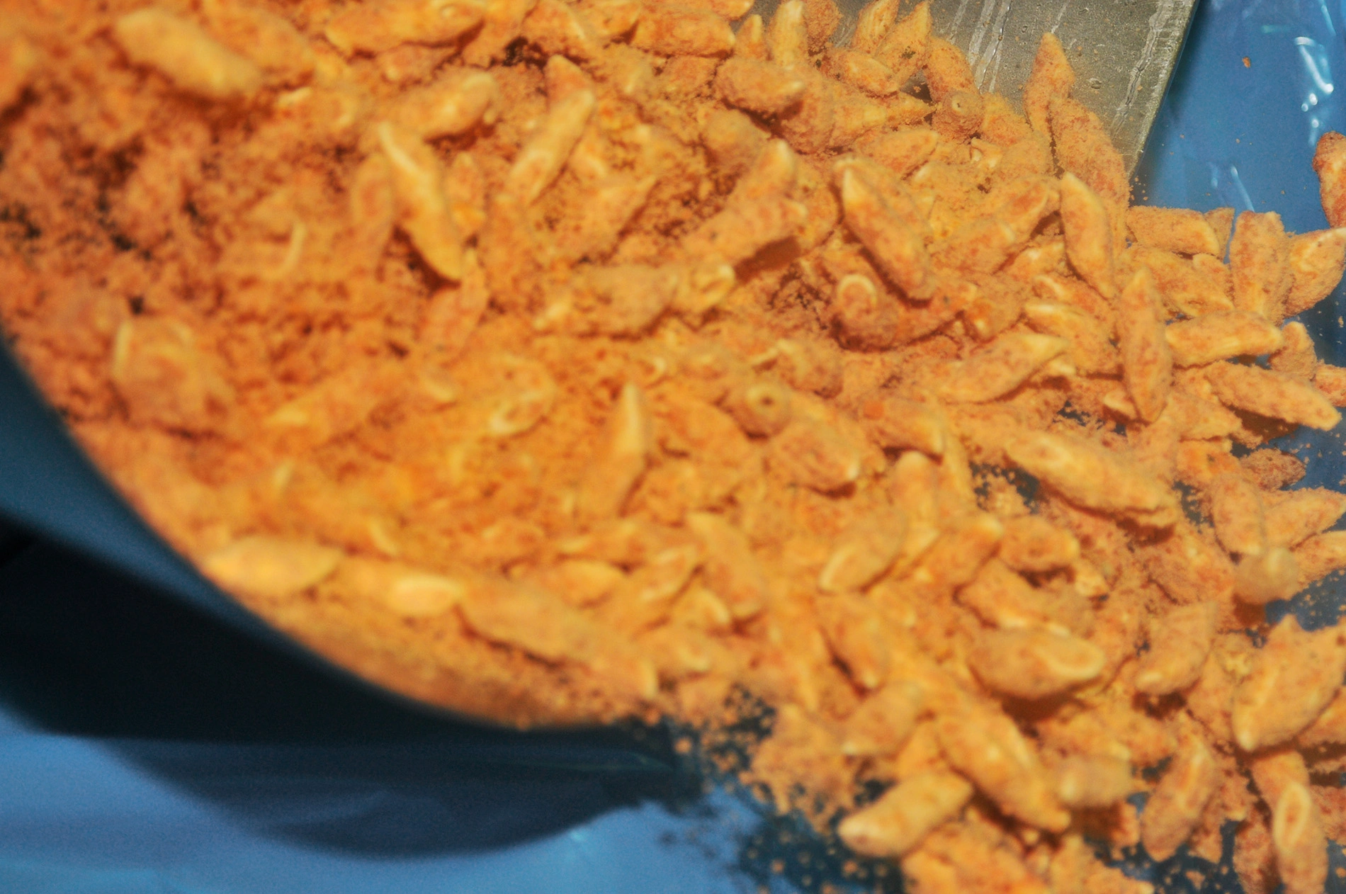 Individually quick frozen breaded pasta pieces in blue container showing successful product separation after cryogenic IQF process
