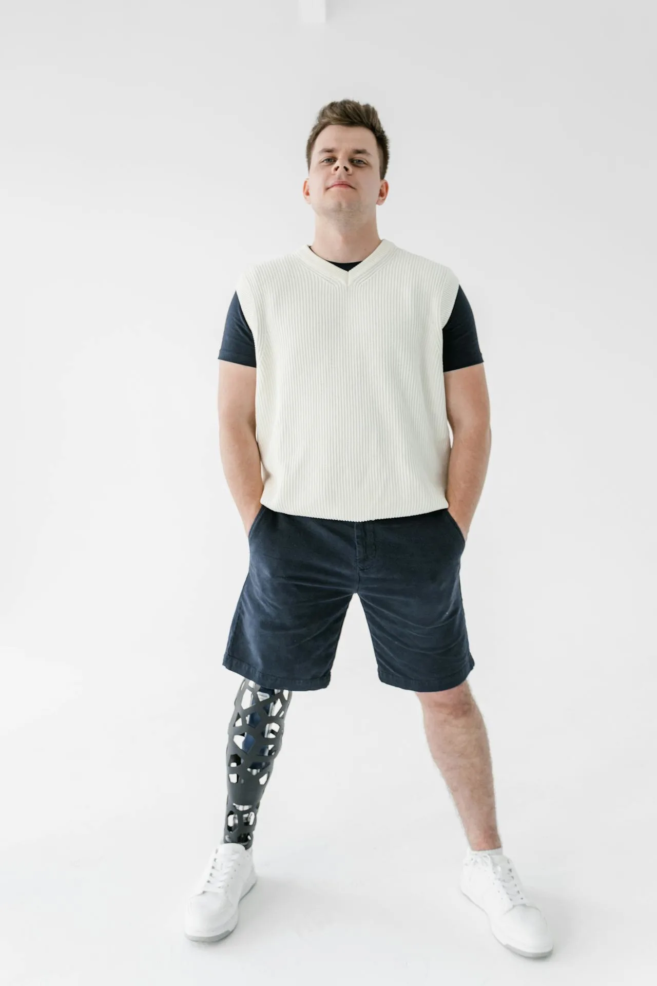 Man showcasing gray tracksuit from Sinners collection