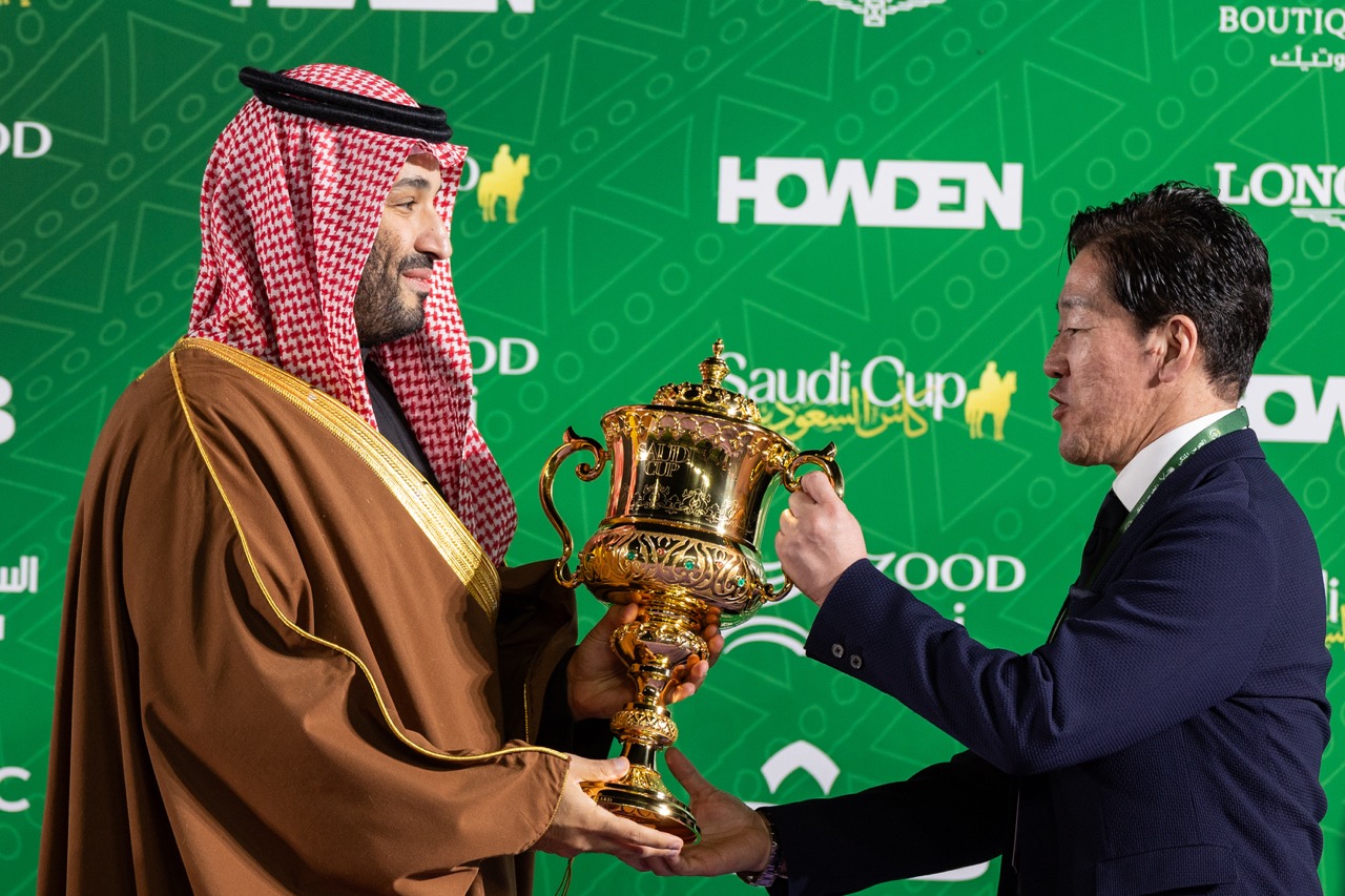 Men hold trophy