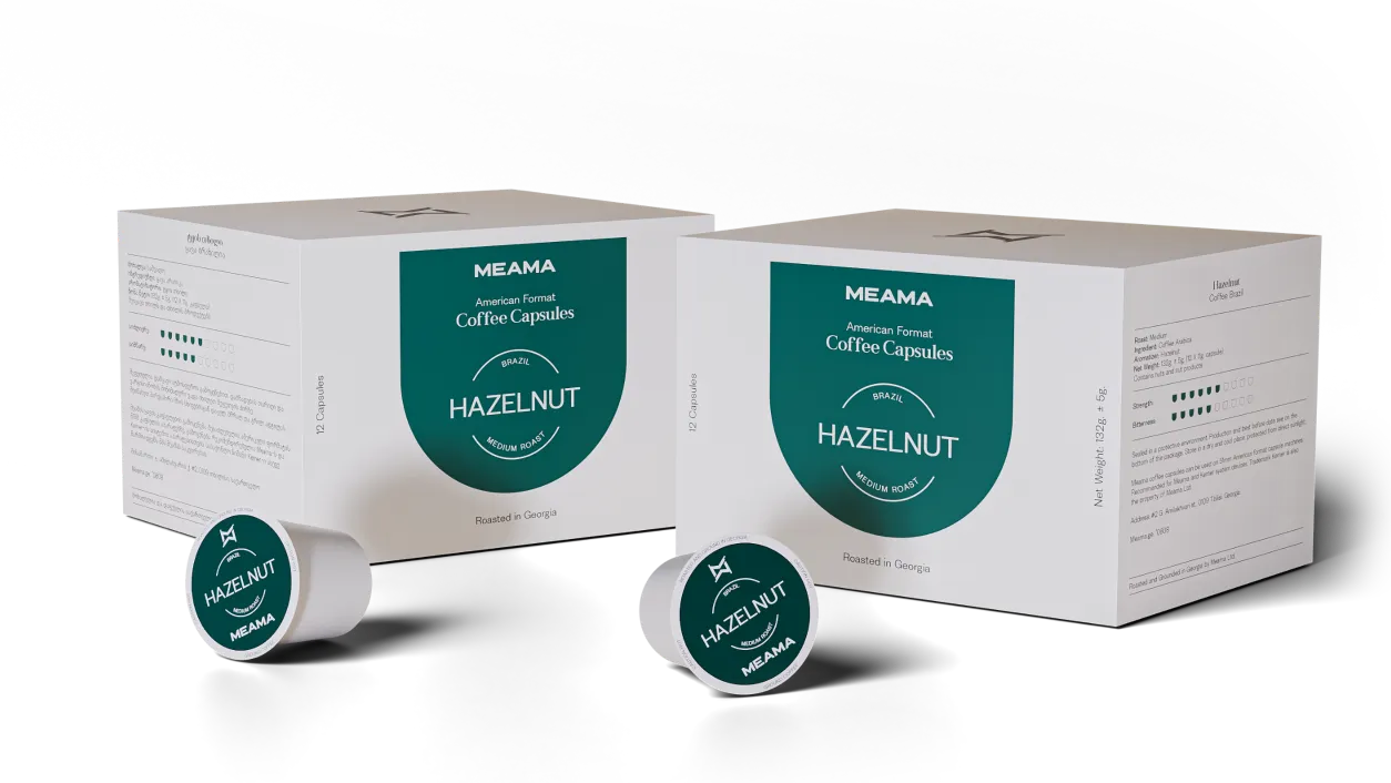 Meama coffee capsule boxes with colorful metallic capsules arranged around them