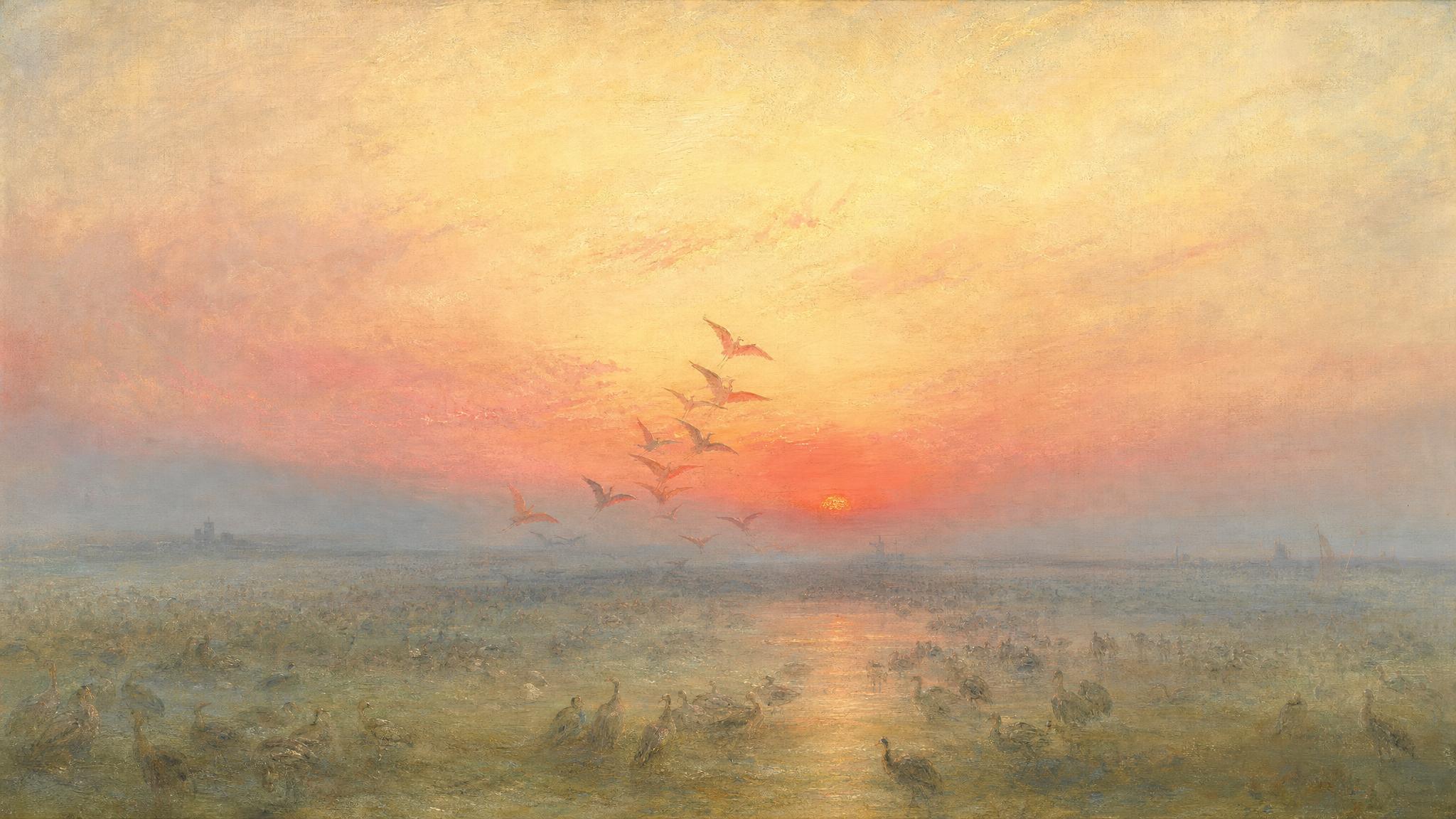 Hundreds of birds rest on a misty plain at rose-gold dawn while only a few rise into flight toward the glowing horizon.