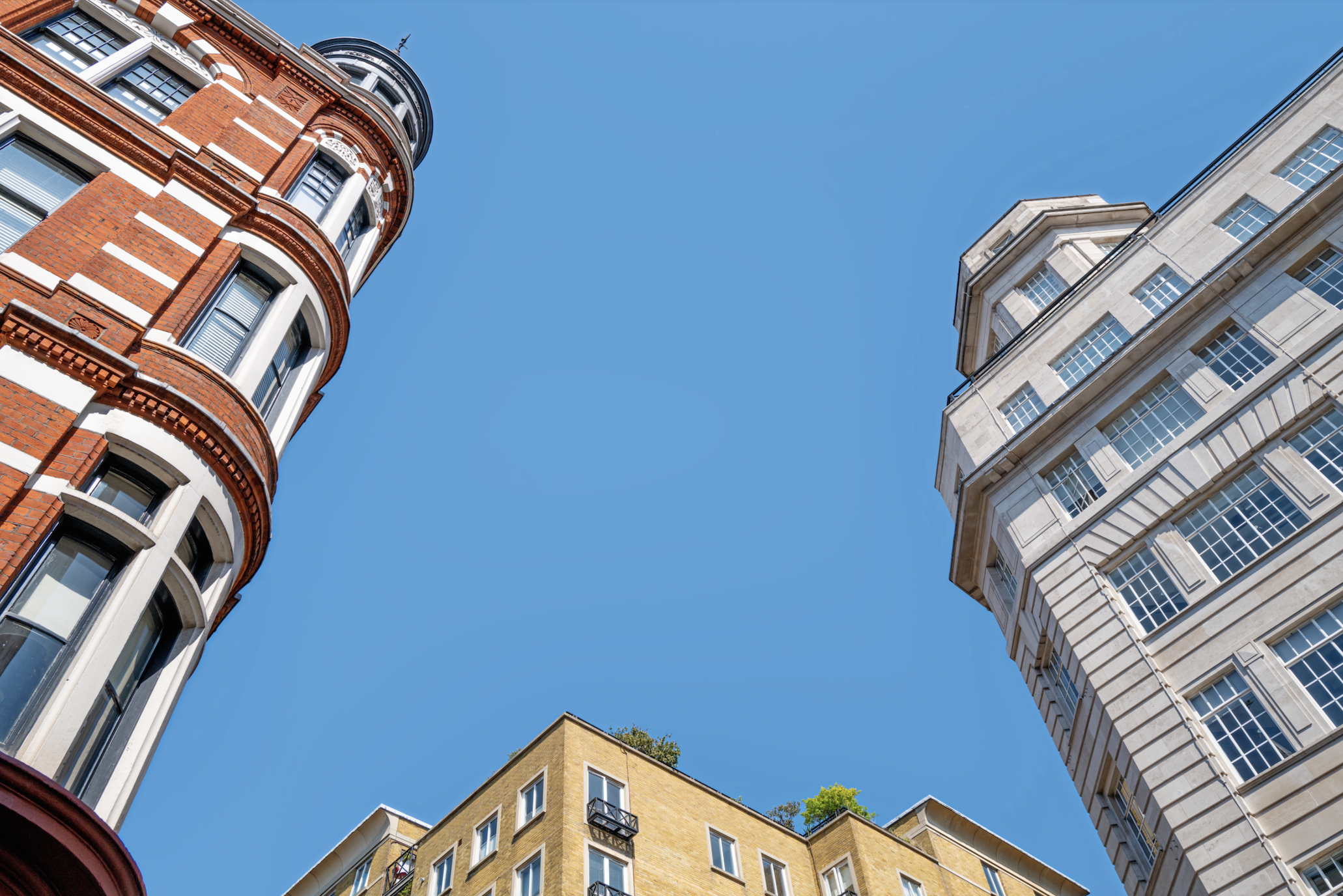 High rise buildings against blue skies.