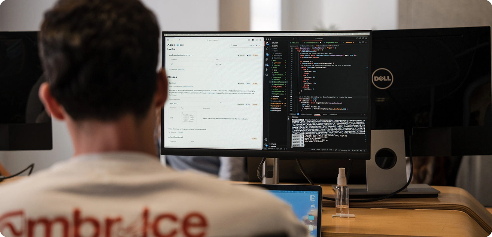 A man sitting in front of a computer screen with code.