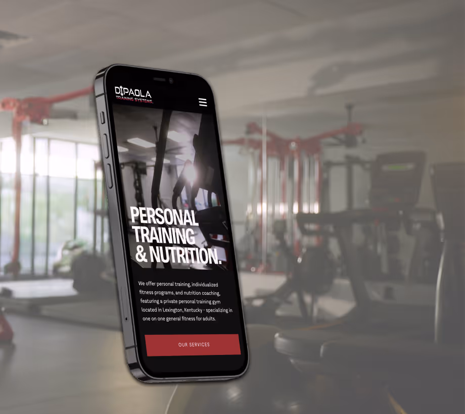A smartphone displays a fitness website in a gym setting. The screen reads "Personal Training & Nutrition" with equipment visible in the blurred background.