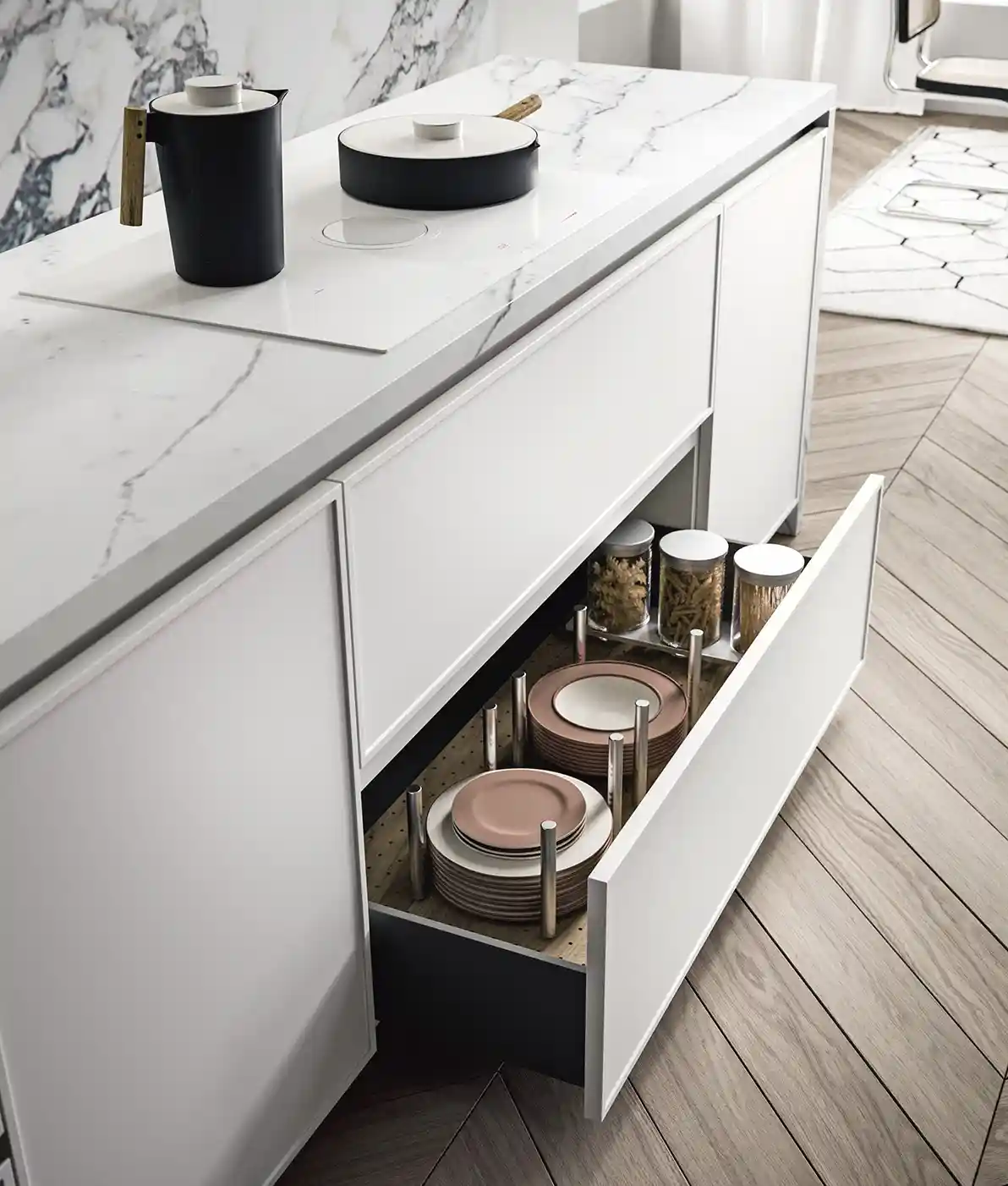 Modern white kitchen drawer open showing neatly organized plates and glass jars with pasta.