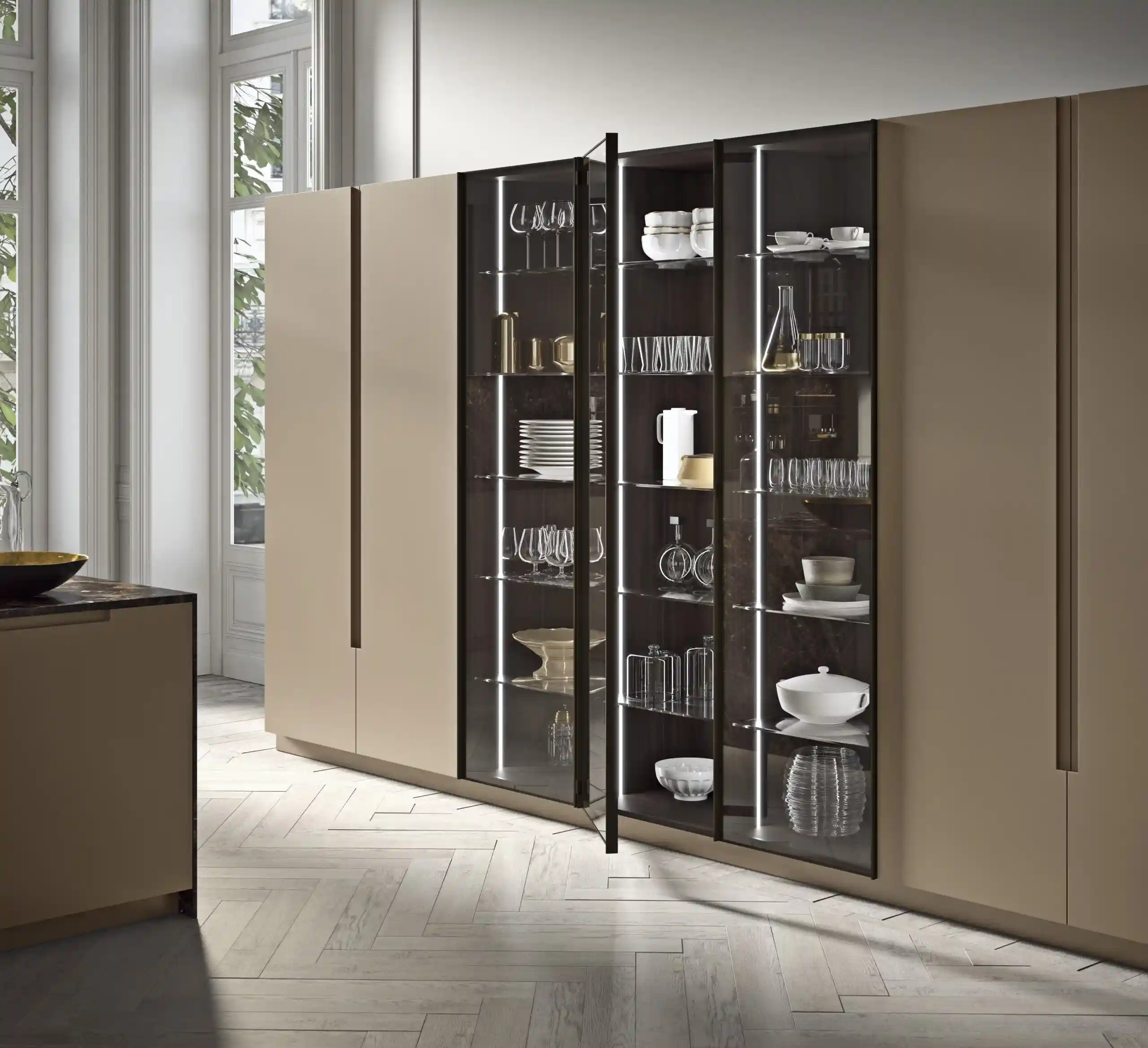 Stack of three decorative cushions with abstract multicolored patterns on a cream textured sofa against a muted pink wall.