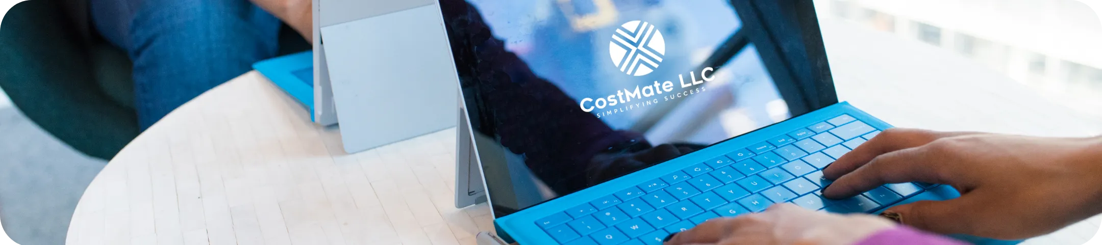 Banner showing a person using CostMate on their laptop.