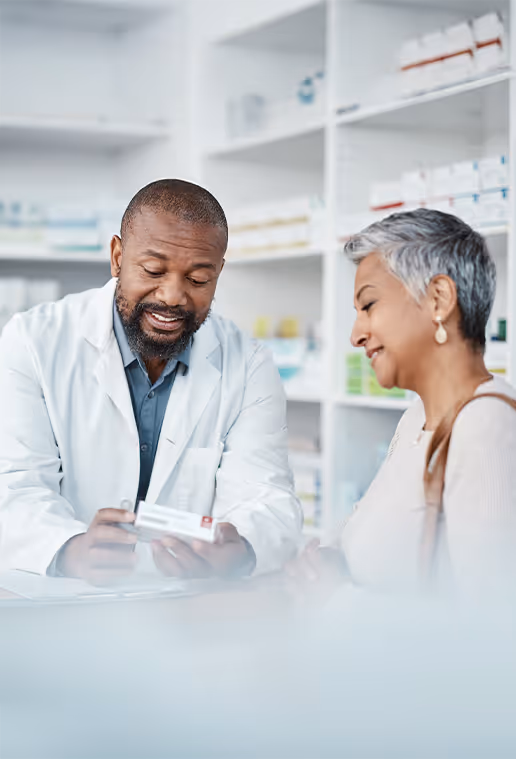 Pharmacist helping older customer with medicine.