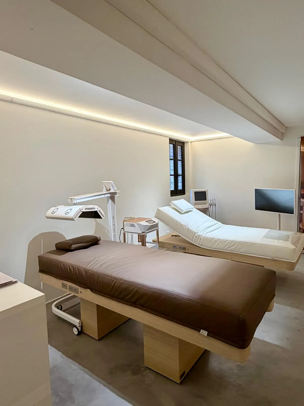 Salle de soins du showroom Nöje avec table de massage chauffante et équipements esthétiques