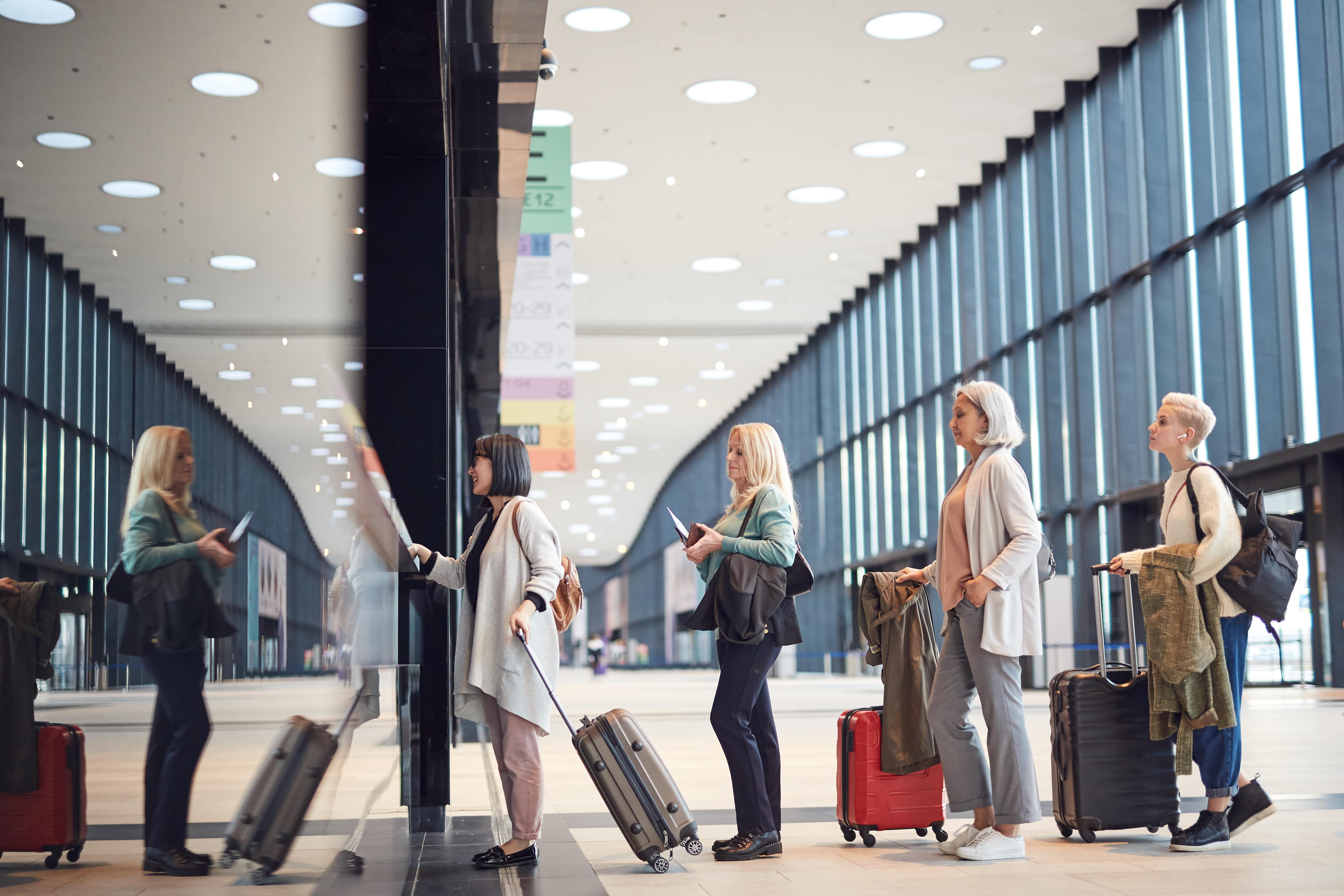 People in queue at check-in counter at an airport