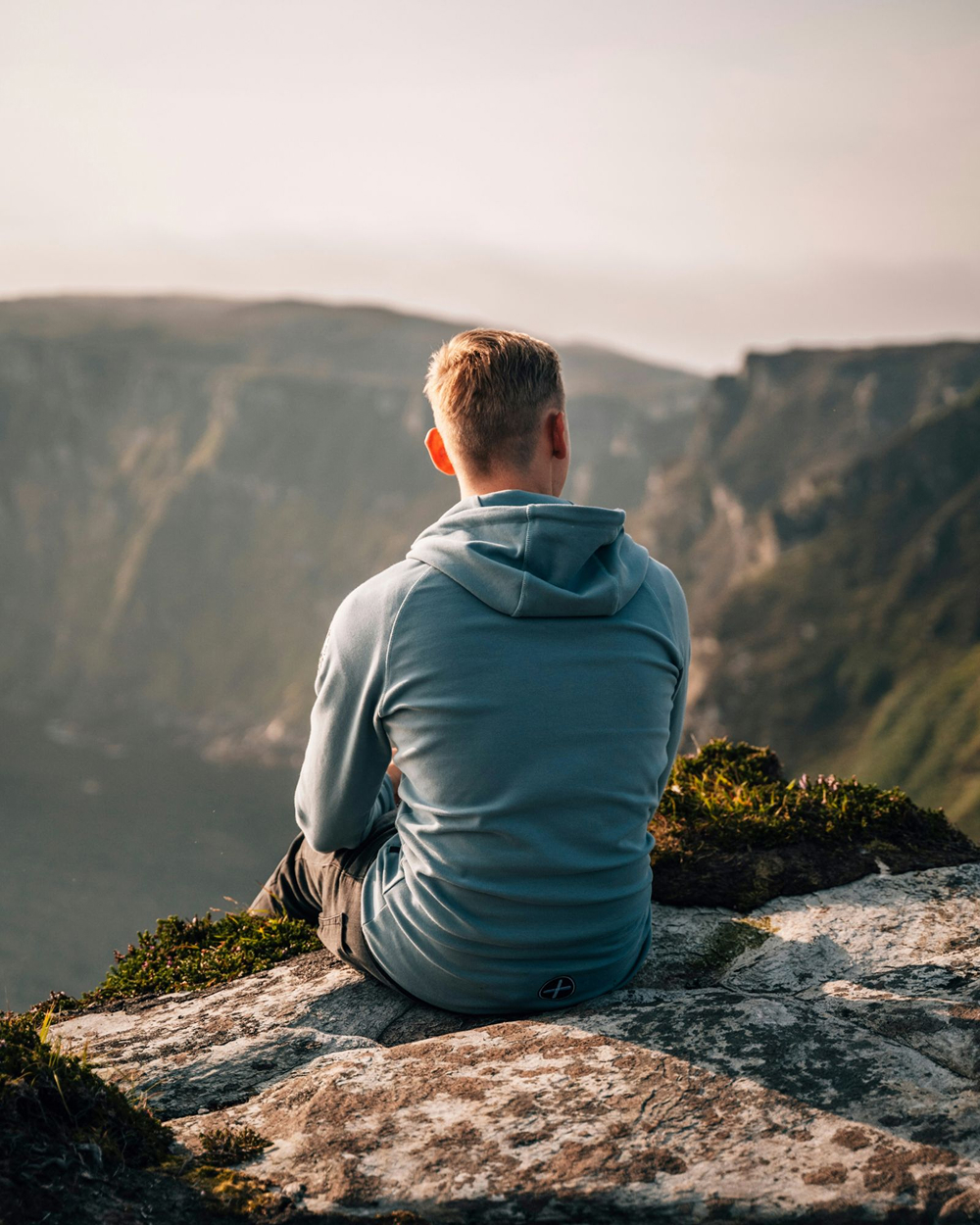 Amen sitting on the ledge looking at the view