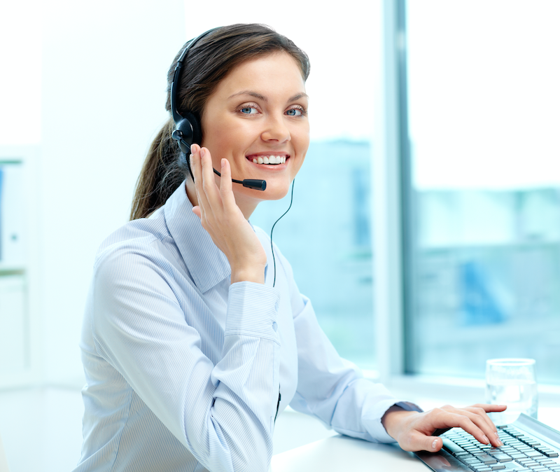 Woman in customer service with a headset and a keyboard.