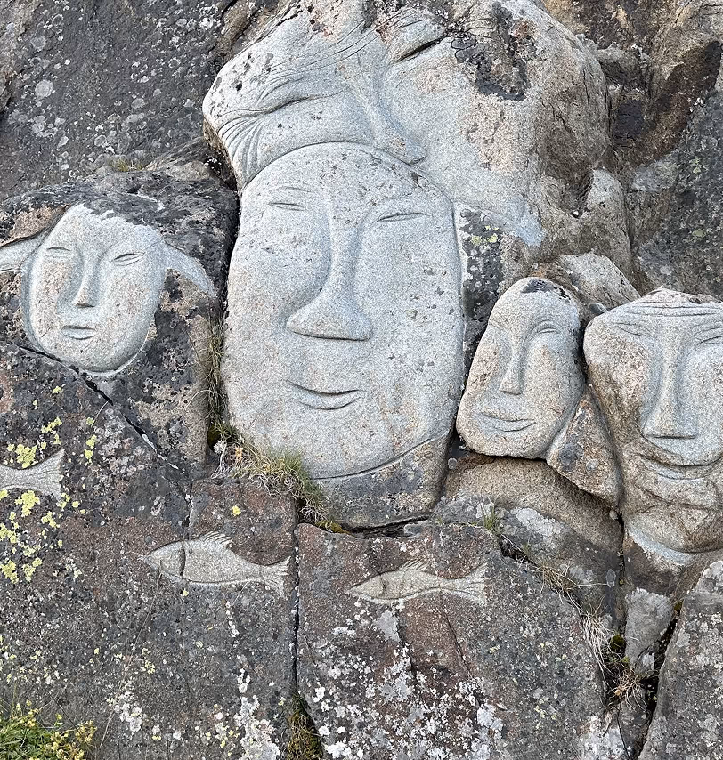 A series of faces carved in stone