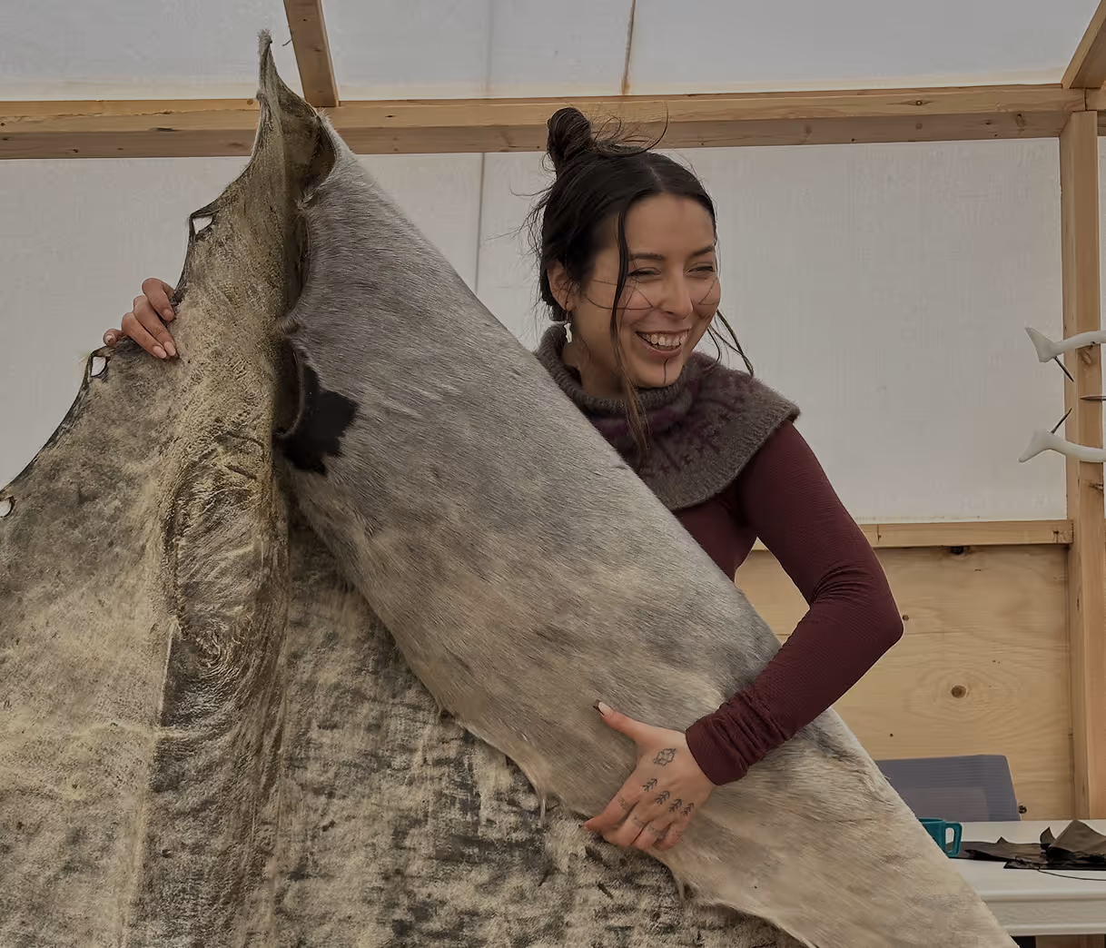 a woman holding a treated animal skin