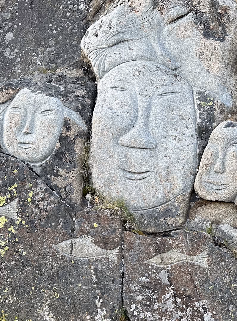 several faces carved in stone
