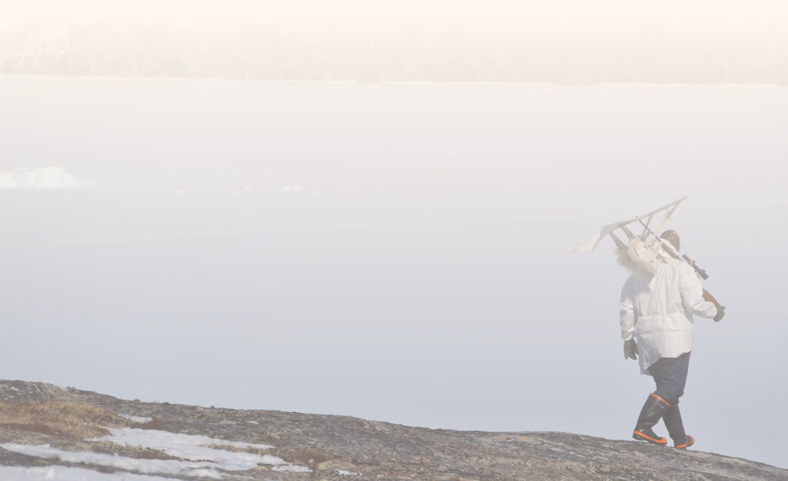 A man walks across the tundra