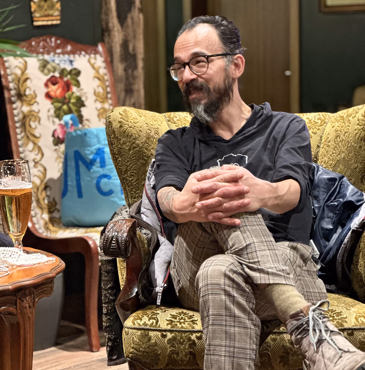 A man sits in a chair and participates in a meeting