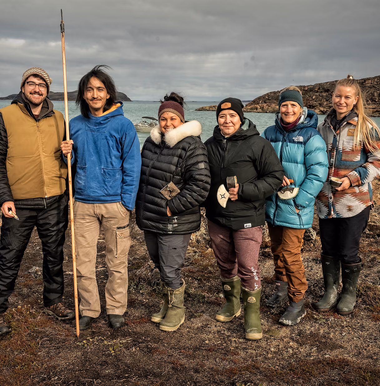 The INF team smiles standing outside in Nunavut