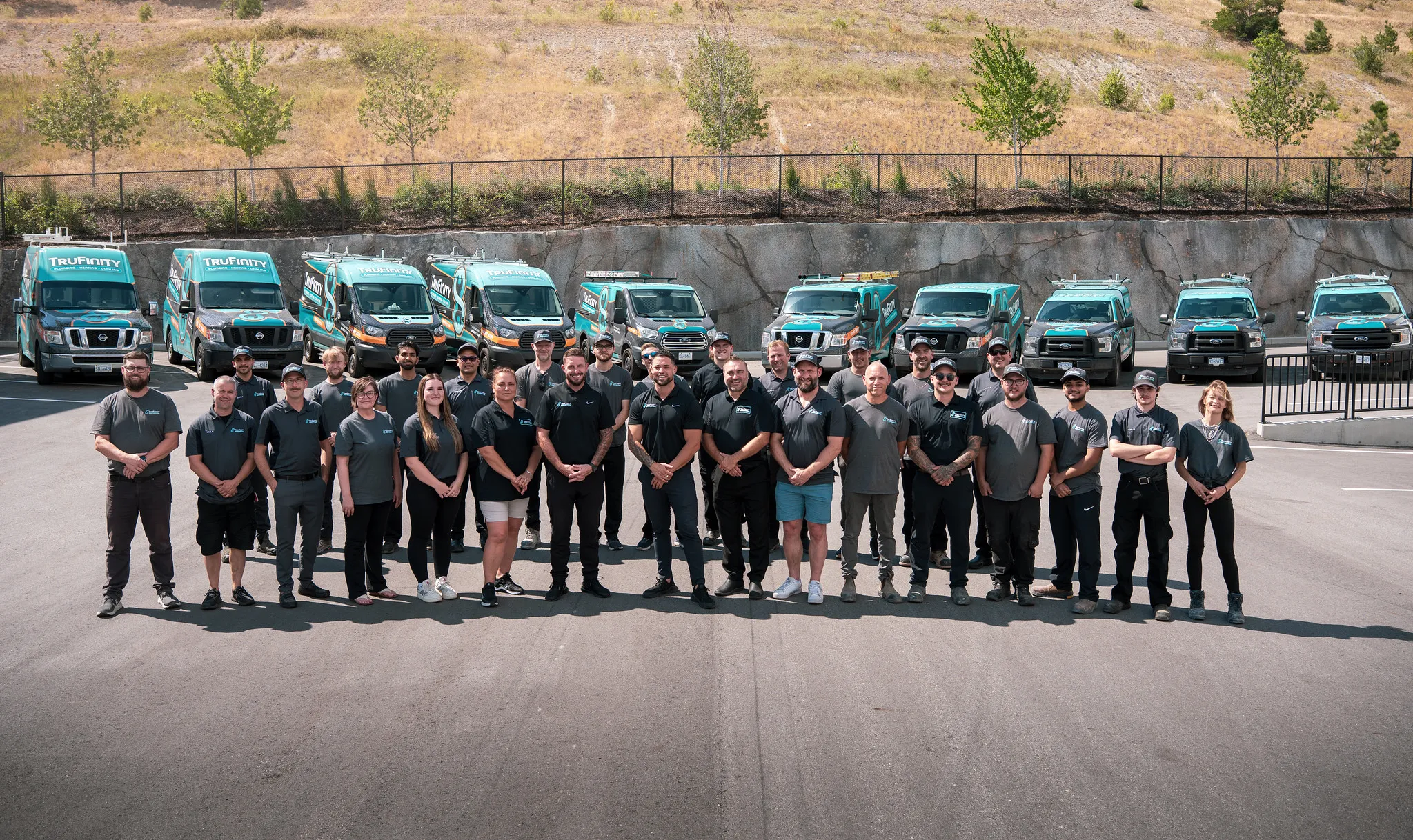 The Trufinity Plumbing & Heating team standing in front of their Kelowna headquarters, providing expert plumbing and HVAC services.
