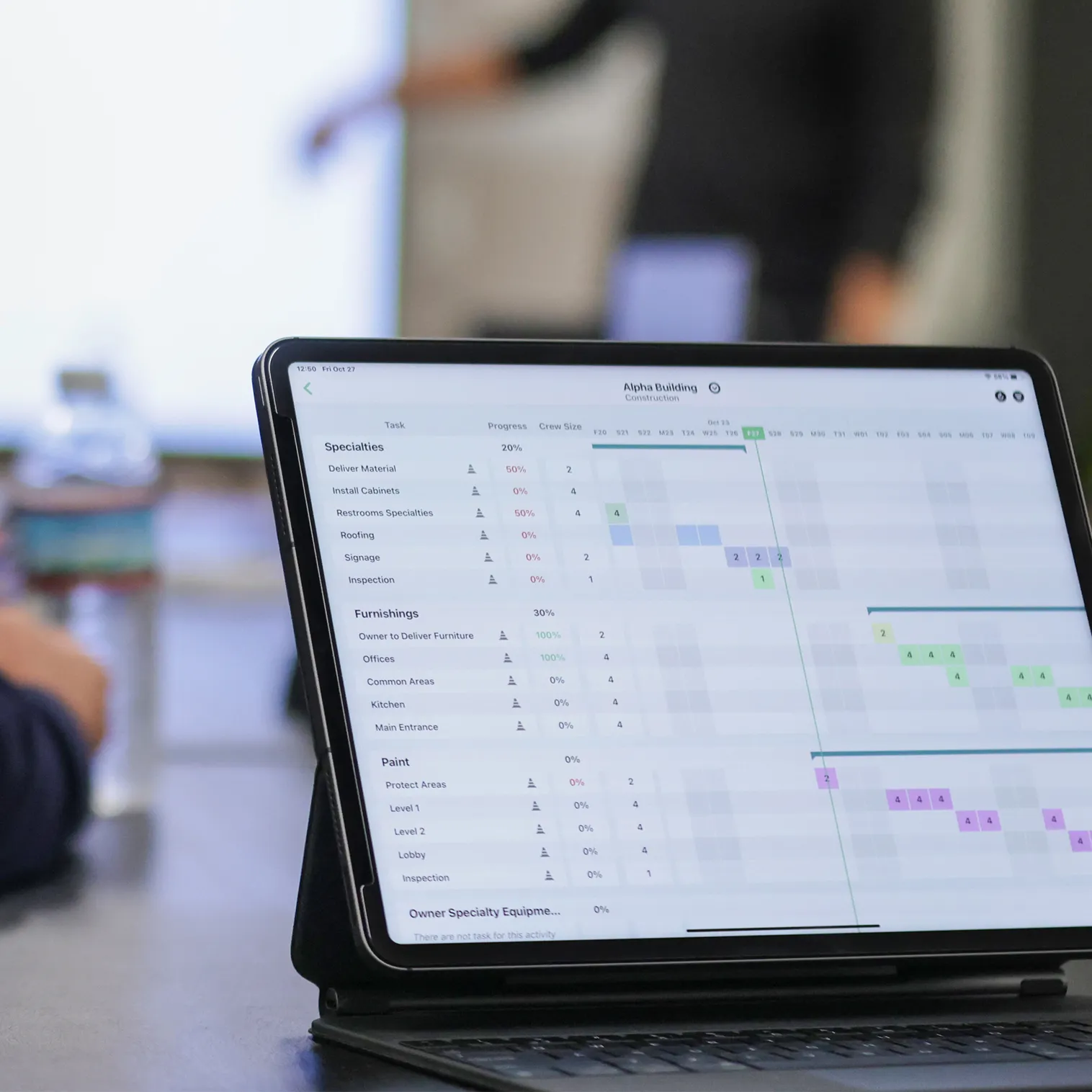 Photo of Outbuild's construction scheduling software being use from an iPad