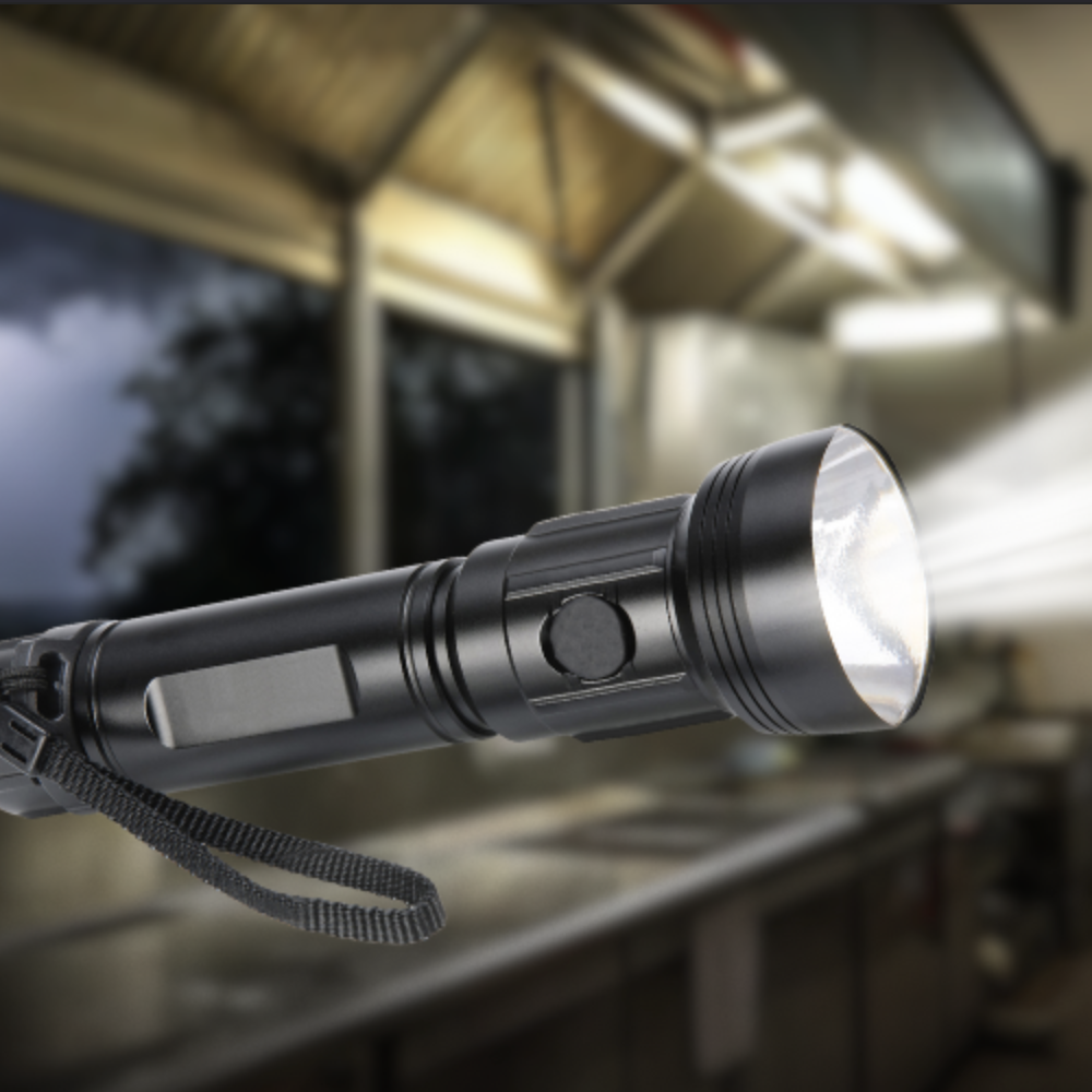 Flashlight illuminating a commercial kitchen during a power outage with lightning outside.