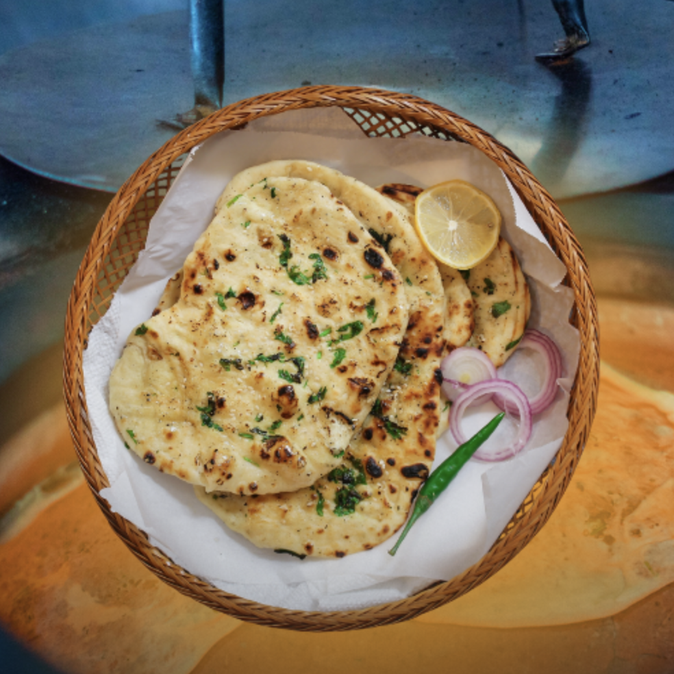Tandoori naan bread served with onion, chili, and lemon.