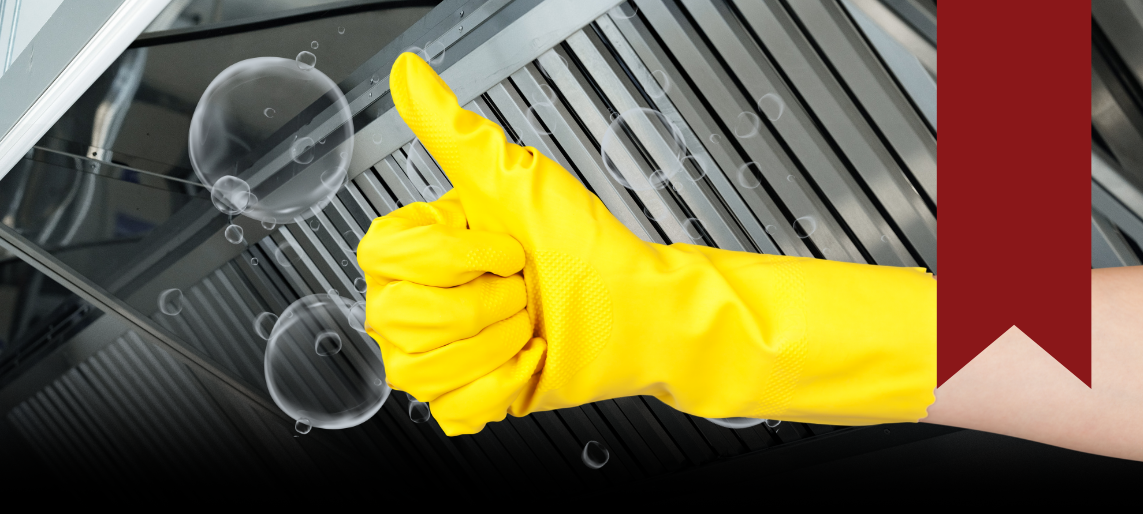Person wearing yellow cleaning gloves giving a thumbs up near a clean commercial kitchen hood.