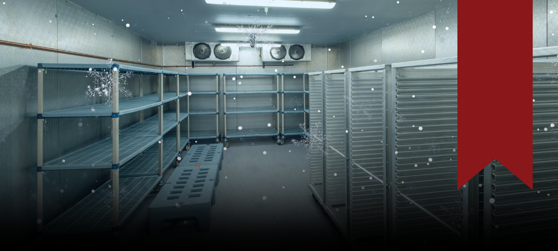 Empty commercial walk-in freezer with shelving and cooling fans.