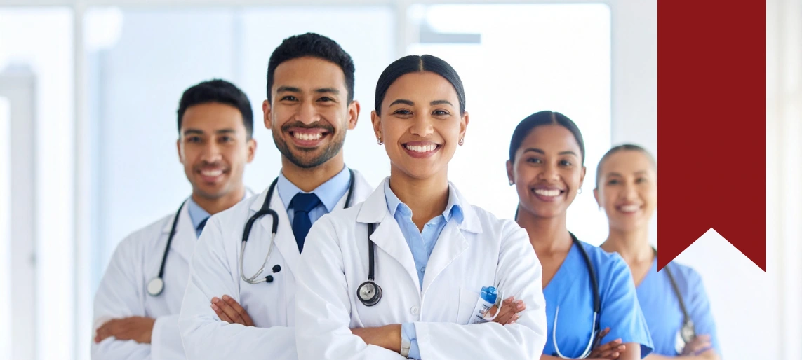 Healthcare professionals standing together in medical uniforms, representing infection control and patient safety