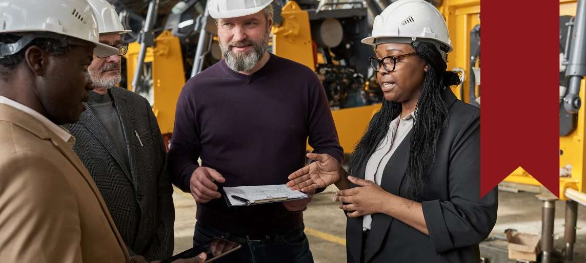 Team in hard hats inspecting equipment and reviewing documents during an ice machine freight inspection