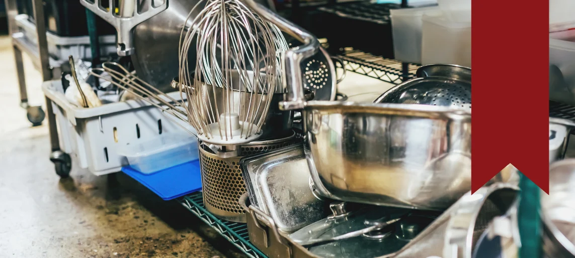 Commercial kitchen smallwares and prep tools stored on open shelving, supporting efficient foodservice workflows in institutional and healthcare kitchens with Aldevra.