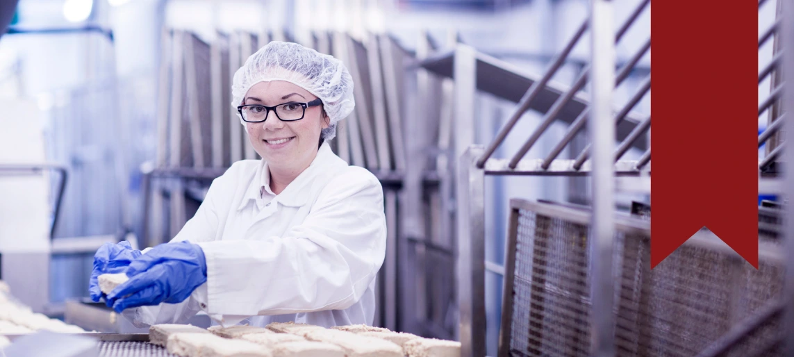 Cannabis kitchen staff member following food safety and sanitation procedures in a compliant production environment, supporting efficient, regulated edible manufacturing with Aldevra.