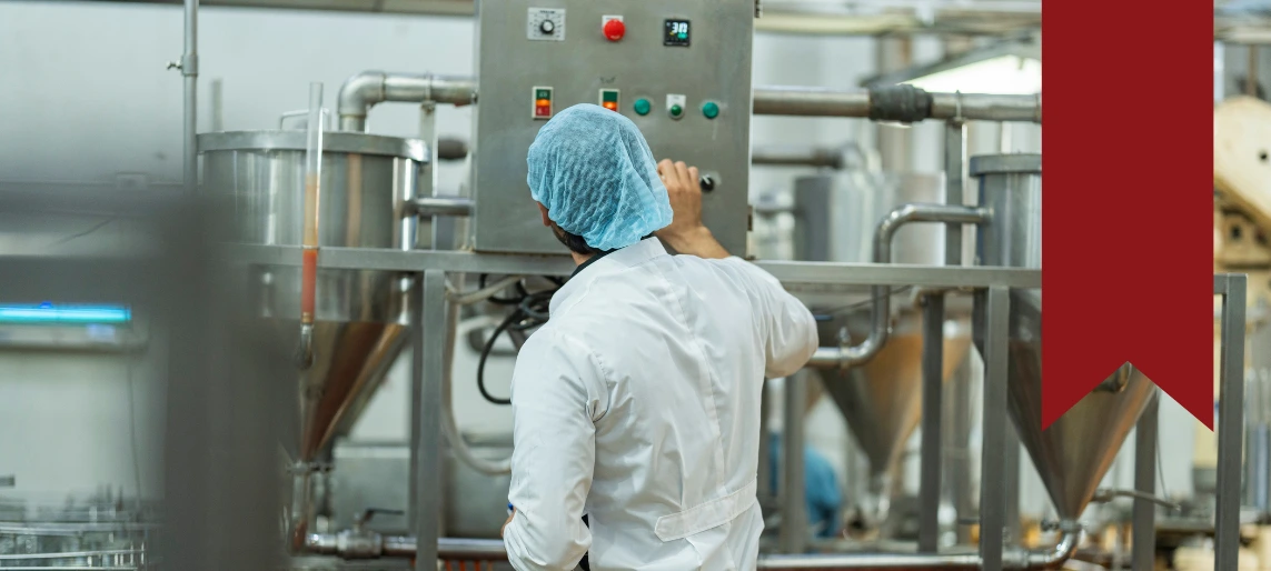 Cannabis edibles production process with operator monitoring automated mixing equipment in a compliant food manufacturing environment supported by Aldevra.